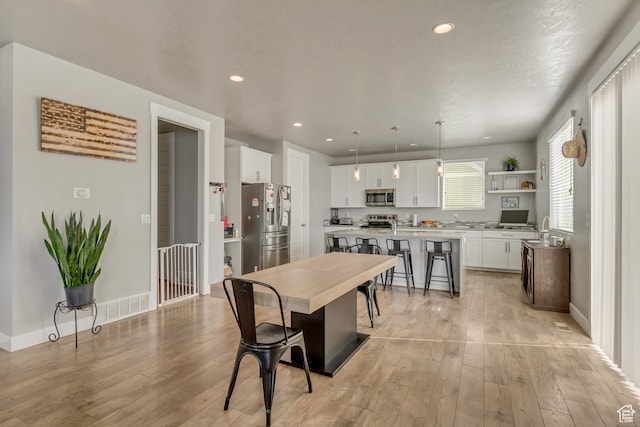 9452 S Alane Hollow Rd W, West Jordan, UT 84081 - dining room featuring baseboards, recessed lighting, and light wood-style floors