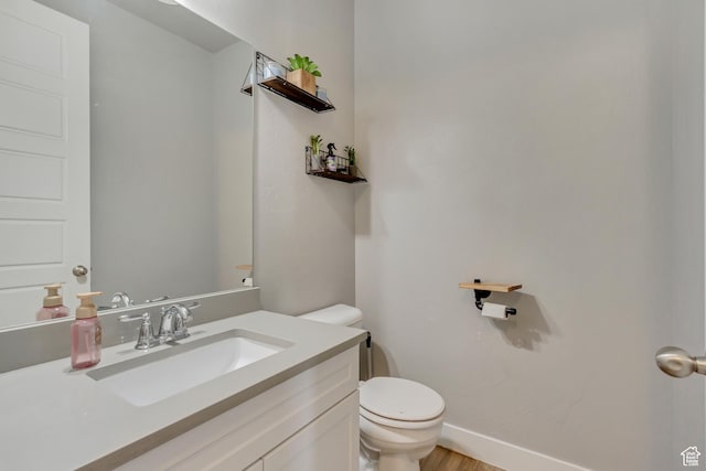9452 S Alane Hollow Rd W, West Jordan, UT 84081 - bathroom featuring toilet, wood finished floors, vanity, and baseboards