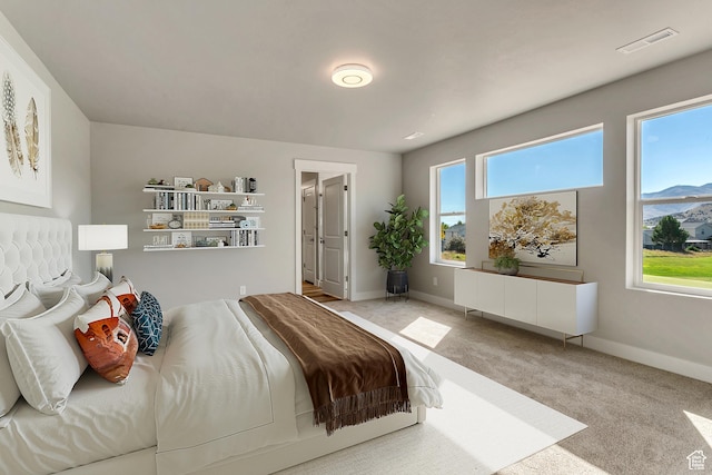 carpeted bedroom with visible vents and baseboards