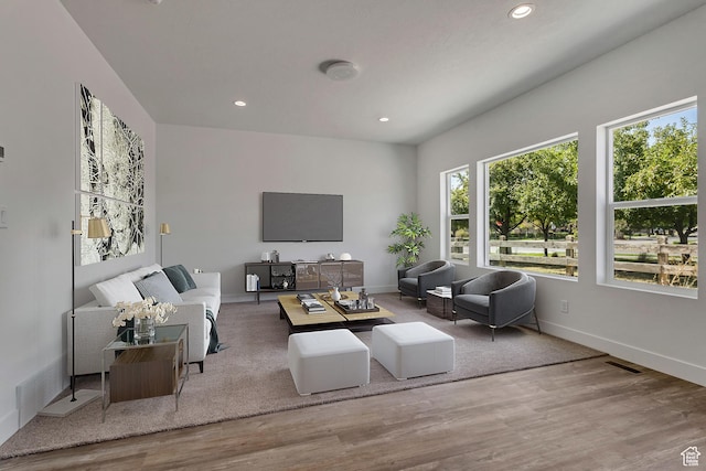 living room featuring wood finished floors, baseboards, visible vents, and recessed lighting