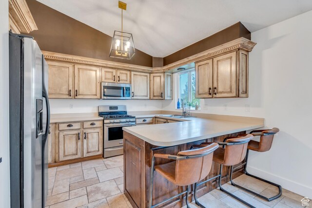 996 W 1340 N, Orem, UT 84057 - kitchen with light countertops, a kitchen breakfast bar, a peninsula, vaulted ceiling, and stainless steel appliances