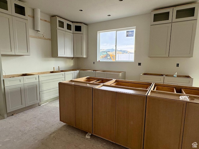 341 N Barlow Ct, Saratoga Springs, UT 84045 - kitchen featuring glass insert cabinets, light floors, and a sink