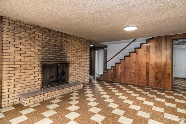 1520 Rushton St, Ogden, UT 84401 - finished below grade area featuring wooden walls, stairs, a fireplace, and a textured ceiling