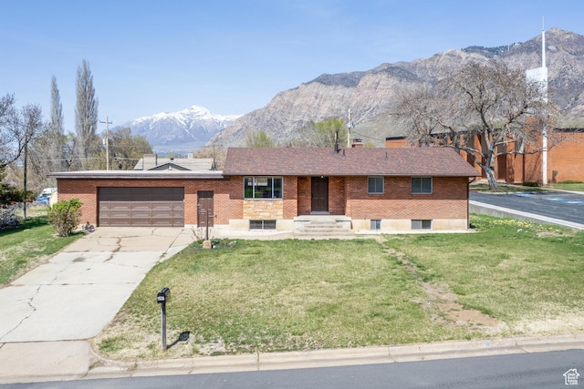 1520 Rushton St, Ogden, UT 84401 - ranch-style house with an attached garage, a mountain view, a front lawn, and brick siding
