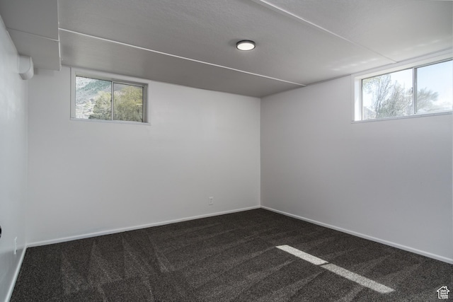 1520 Rushton St, Ogden, UT 84401 - basement with dark carpet, a healthy amount of sunlight, and baseboards