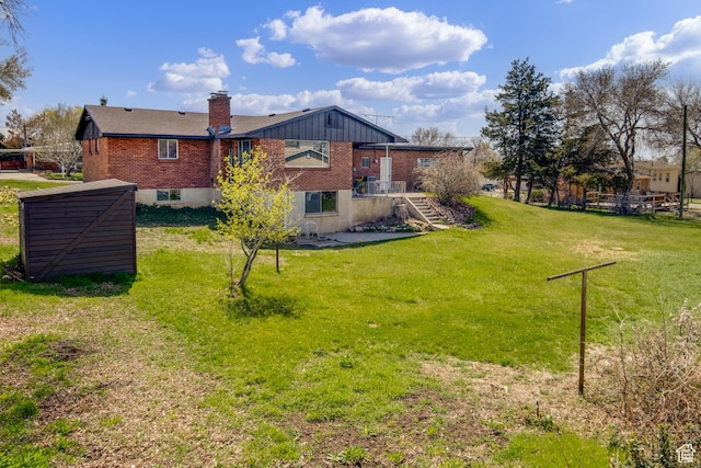 1520 Rushton St, Ogden, UT 84401 - rear view of property featuring board and batten siding, a lawn, stairway, brick siding, and a chimney