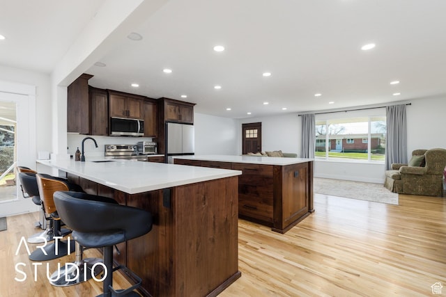 379 E 100 S, Kaysville, UT 84037 - kitchen featuring open floor plan, stainless steel appliances, recessed lighting, and light wood-style flooring