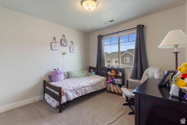 carpeted bedroom with visible vents and baseboards