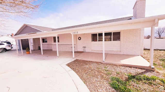 1018 N 3500 W, Vernal, UT 84078 - ranch-style house with a chimney, a garage, and brick siding