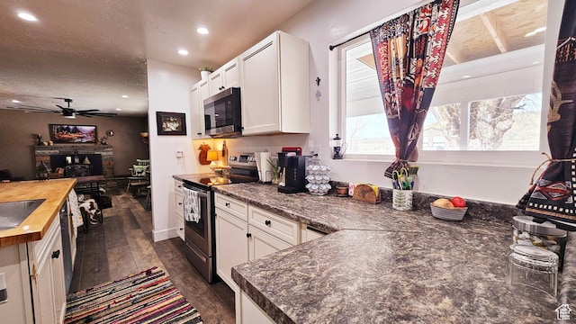 1018 N 3500 W, Vernal, UT 84078 - kitchen with a ceiling fan, wooden counters, white cabinets, dark wood finished floors, and stainless steel appliances