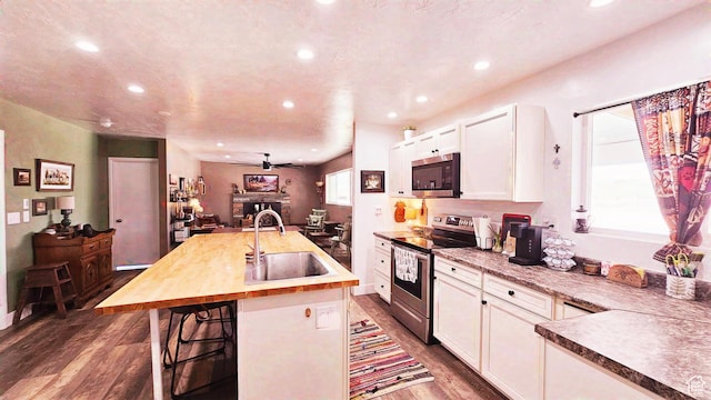1018 N 3500 W, Vernal, UT 84078 - kitchen with dark wood-type flooring, white cabinetry, recessed lighting, a sink, and stainless steel appliances