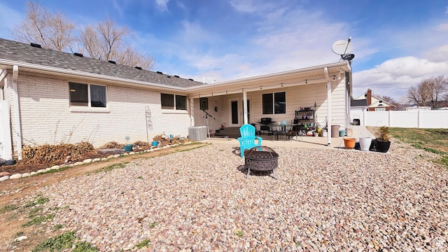 1018 N 3500 W, Vernal, UT 84078 - rear view of house with a fire pit, a patio, fence, and brick siding