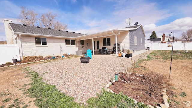 1018 N 3500 W, Vernal, UT 84078 - rear view of property with a fire pit, a patio area, brick siding, central AC unit, and a fenced backyard
