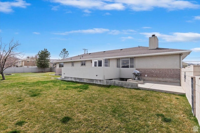 14883 S 3200 W, Bluffdale, UT 84065 - back of house with brick siding, a fenced backyard, a chimney, and a lawn