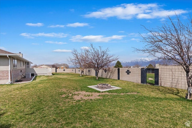 14883 S 3200 W, Bluffdale, UT 84065 - view of yard with central AC unit, a fenced backyard, a fire pit, and a gate