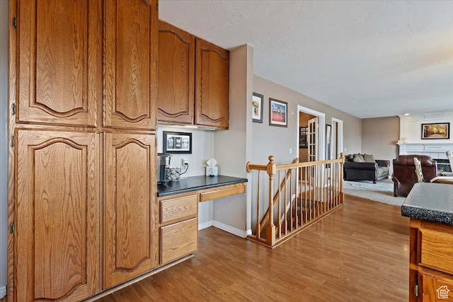 14883 S 3200 W, Bluffdale, UT 84065 - kitchen with baseboards, open floor plan, dark countertops, brown cabinets, and wood finished floors