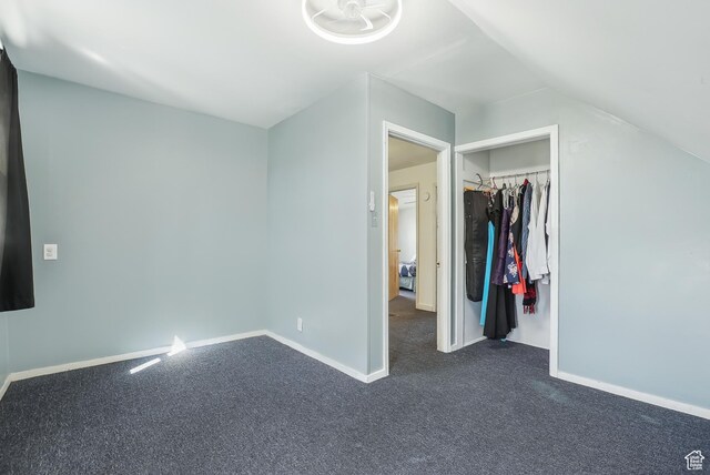 3396 W 3800 S, West Valley City, UT 84119 - unfurnished bedroom with baseboards, a closet, dark colored carpet, and lofted ceiling