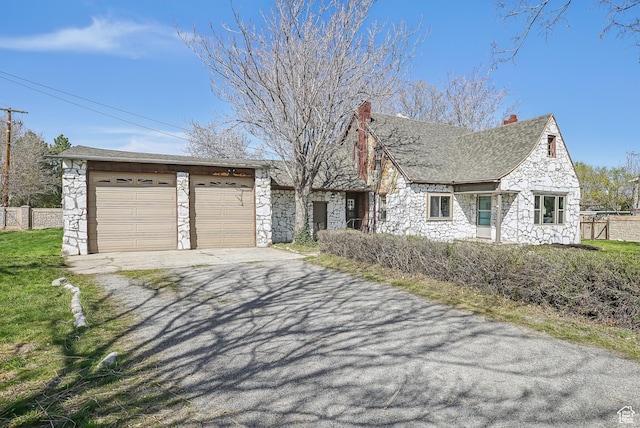 3396 W 3800 S, West Valley City, UT 84119 - view of front facade featuring a chimney, fence, and stone siding