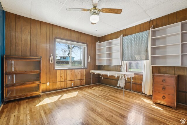 3396 W 3800 S, West Valley City, UT 84119 - unfurnished office featuring light wood-style flooring, wood walls, and a ceiling fan