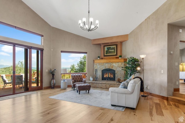 10129 N Basin Canyon Rd, Park City, UT 84098 - living room featuring a towering ceiling, a stone fireplace, a chandelier, a wealth of natural light, and wood finished floors