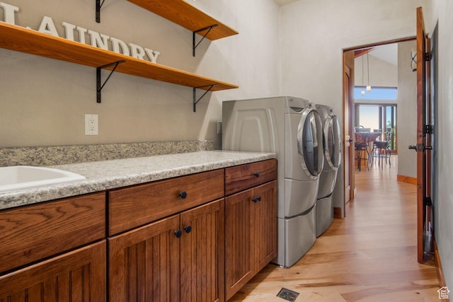 10129 N Basin Canyon Rd, Park City, UT 84098 - laundry room featuring light wood finished floors, a sink, washing machine and clothes dryer, and cabinet space