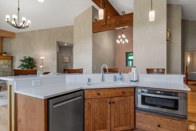 10129 N Basin Canyon Rd, Park City, UT 84098 - kitchen featuring a sink, light countertops, appliances with stainless steel finishes, and a notable chandelier