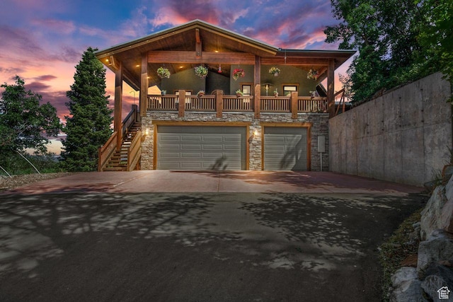 10129 N Basin Canyon Rd, Park City, UT 84098 - view of front of home featuring concrete driveway, stairs, stone siding, and an attached garage