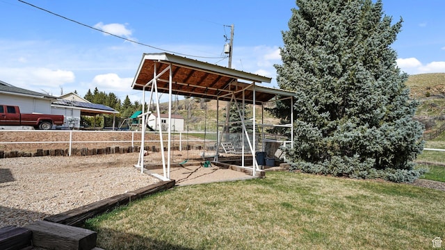 view of outbuilding with fence and a playground