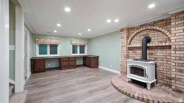 unfurnished office with light wood-style floors, a wood stove, baseboards, and recessed lighting