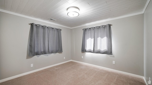 spare room featuring baseboards, ornamental molding, visible vents, carpet, and wood ceiling