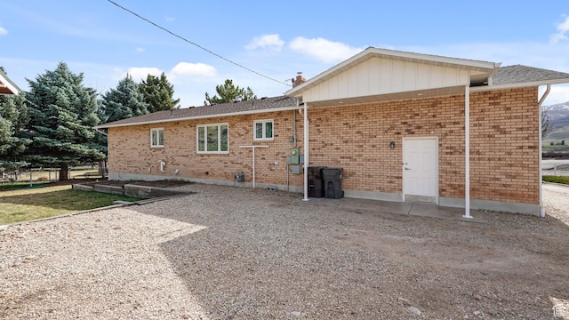 back of house featuring brick siding