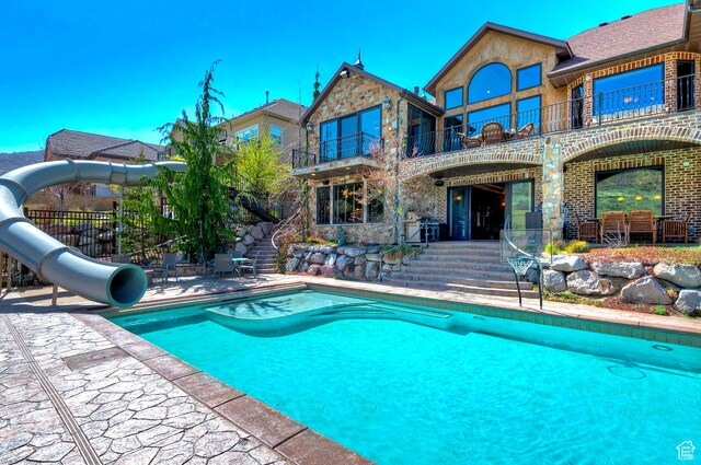 13879 S Standing Oak Dr E, Draper, UT 84020 - pool with a patio, a water slide, and fence