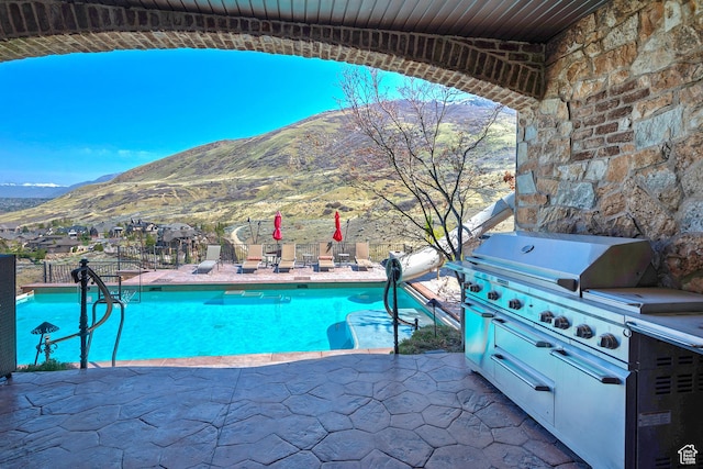 13879 S Standing Oak Dr E, Draper, UT 84020 - view of swimming pool featuring a patio, a mountain view, a fenced in pool, and fence