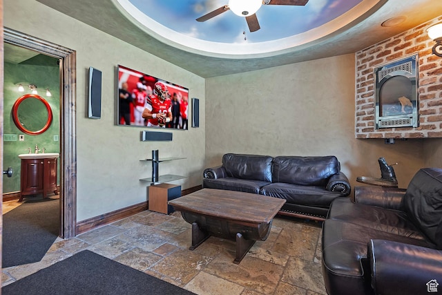 13879 S Standing Oak Dr E, Draper, UT 84020 - living room featuring ceiling fan, baseboards, and stone tile flooring