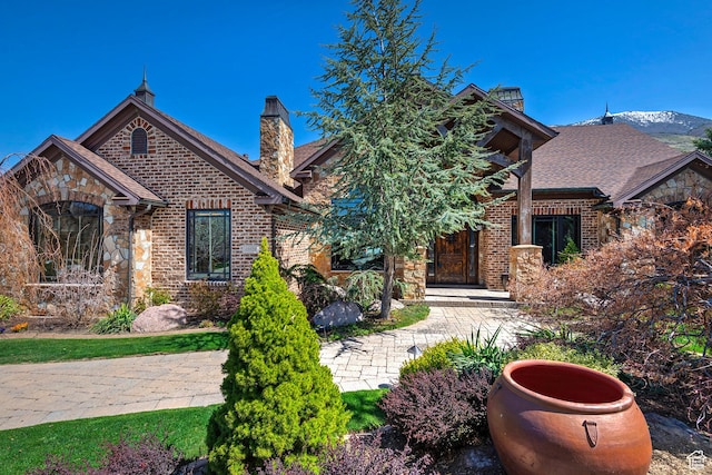 13879 S Standing Oak Dr E, Draper, UT 84020 - view of front of home with brick siding, stone siding, and a chimney