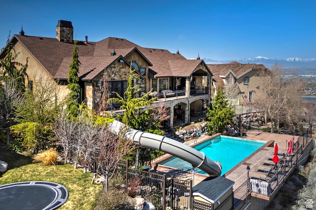 13879 S Standing Oak Dr E, Draper, UT 84020 - view of swimming pool with fence, a water slide, a fenced in pool, and a patio