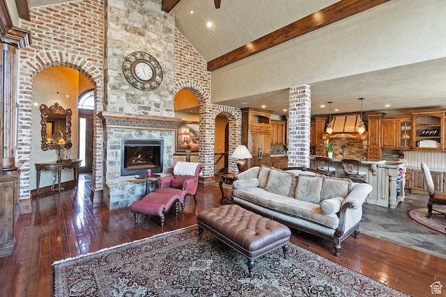 13879 S Standing Oak Dr E, Draper, UT 84020 - living room with arched walkways, decorative columns, dark wood finished floors, beamed ceiling, and high vaulted ceiling