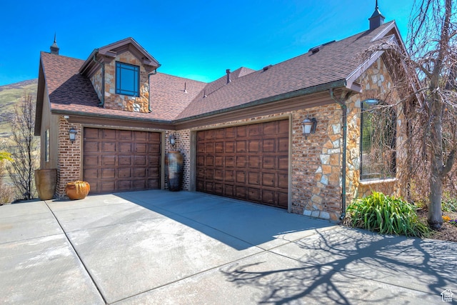 13879 S Standing Oak Dr E, Draper, UT 84020 - view of front of property featuring roof with shingles, driveway, a garage, and stone siding