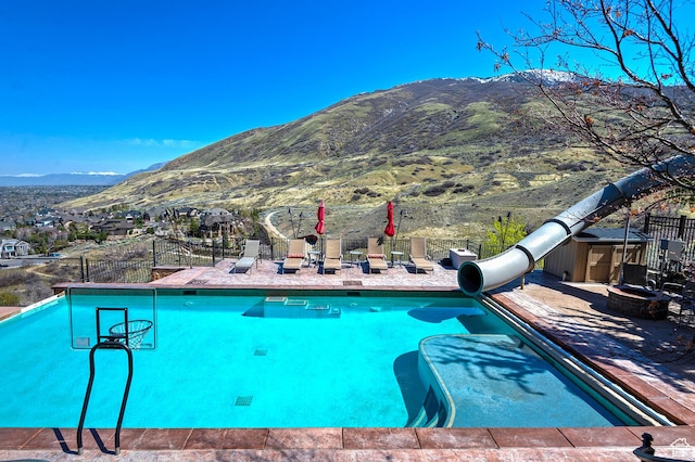 13879 S Standing Oak Dr E, Draper, UT 84020 - view of swimming pool with fence, a mountain view, a water slide, and a fenced in pool