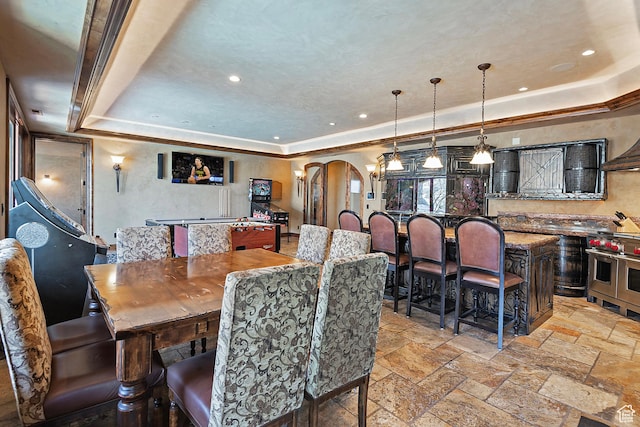 13879 S Standing Oak Dr E, Draper, UT 84020 - dining space featuring recessed lighting, arched walkways, a tray ceiling, and stone tile flooring