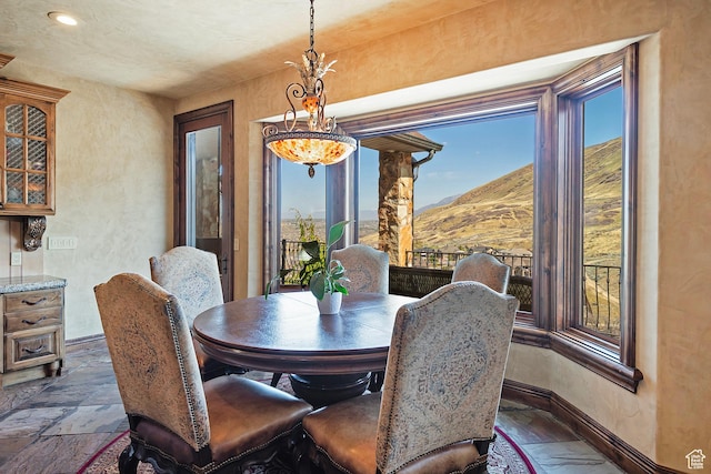 13879 S Standing Oak Dr E, Draper, UT 84020 - dining space featuring recessed lighting, stone finish floor, baseboards, and a mountain view