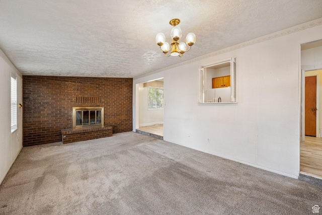 unfurnished living room featuring carpet flooring, a notable chandelier, and a textured ceiling