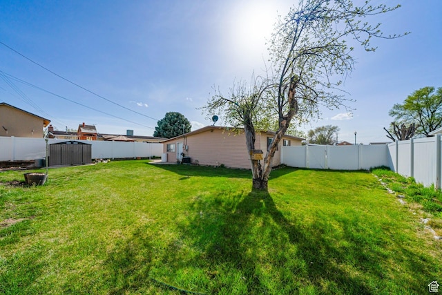 view of yard with a fenced backyard and an outdoor structure