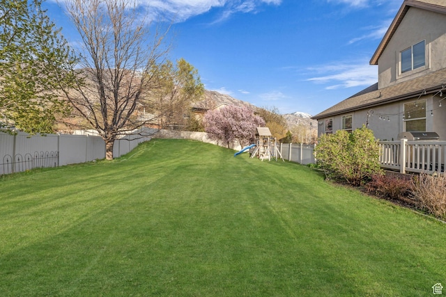 888 W 2800 N, Pleasant Grove, UT 84062 - view of yard featuring a mountain view, a fenced backyard, and a playground