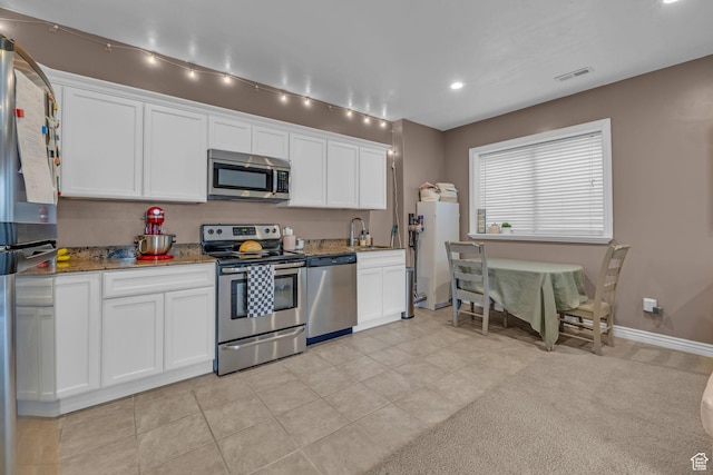 888 W 2800 N, Pleasant Grove, UT 84062 - kitchen featuring light stone counters, white cabinetry, visible vents, stainless steel appliances, and a sink