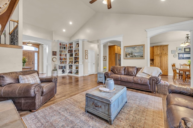 888 W 2800 N, Pleasant Grove, UT 84062 - living room featuring high vaulted ceiling, ornate columns, arched walkways, and ceiling fan with notable chandelier