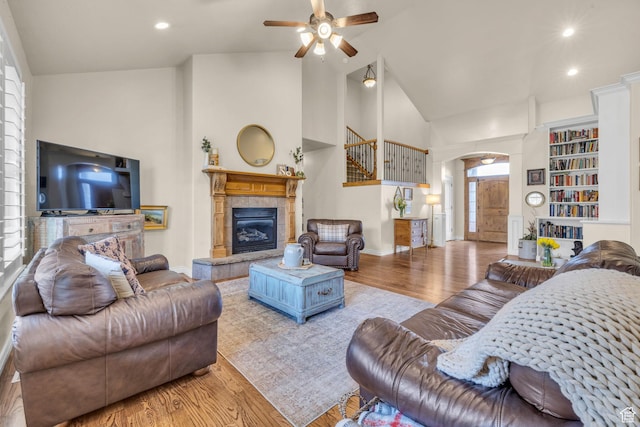 888 W 2800 N, Pleasant Grove, UT 84062 - living area featuring arched walkways, a ceiling fan, wood finished floors, a tile fireplace, and baseboards