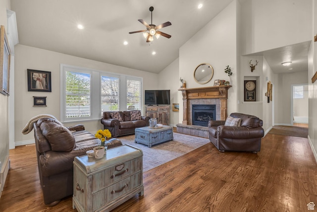888 W 2800 N, Pleasant Grove, UT 84062 - living room with high vaulted ceiling, a ceiling fan, wood finished floors, a healthy amount of sunlight, and a tiled fireplace