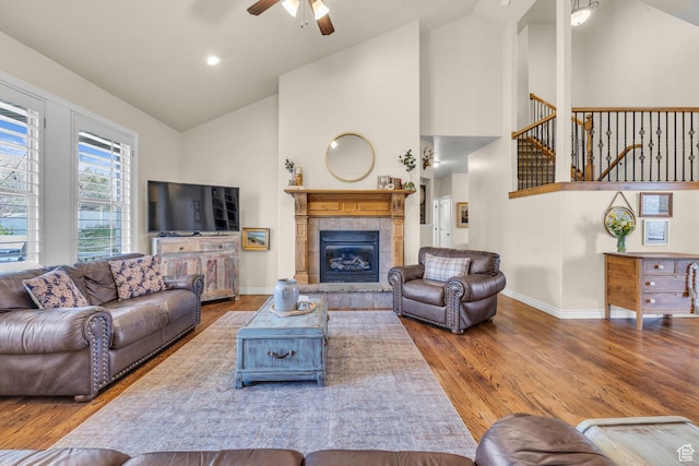 888 W 2800 N, Pleasant Grove, UT 84062 - living room with high vaulted ceiling, a ceiling fan, wood finished floors, a tile fireplace, and baseboards