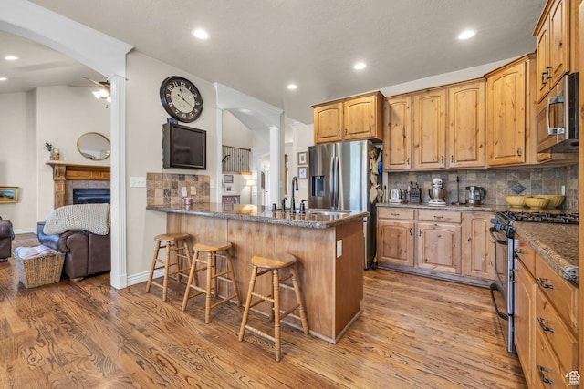 888 W 2800 N, Pleasant Grove, UT 84062 - kitchen featuring recessed lighting, a kitchen breakfast bar, decorative backsplash, and appliances with stainless steel finishes